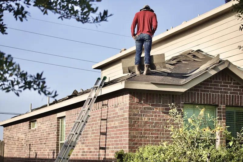 Professional roofer working on a residential roof in Advance